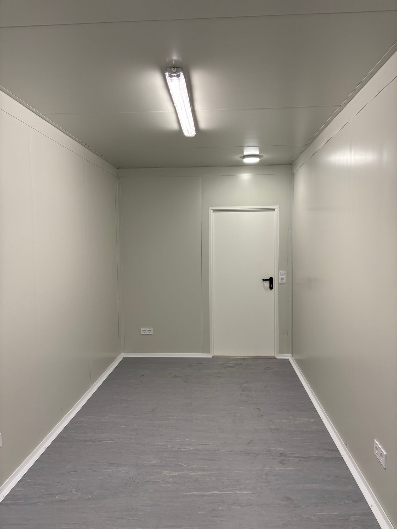 Interior of an office container from Eurocontain with white paint and a door